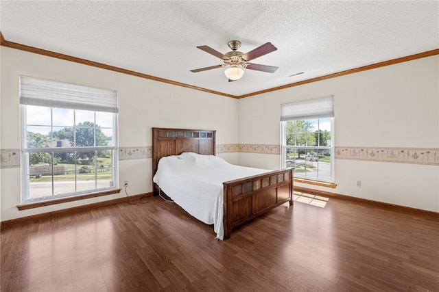 bedroom featuring crown molding, a textured ceiling, ceiling fan, and dark hardwood / wood-style flooring