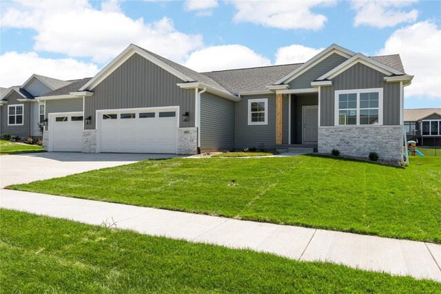 view of front of property with a front lawn and a garage