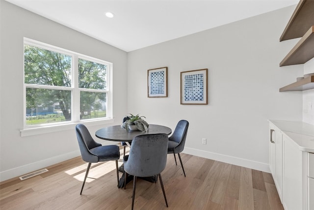 dining space with light hardwood / wood-style flooring