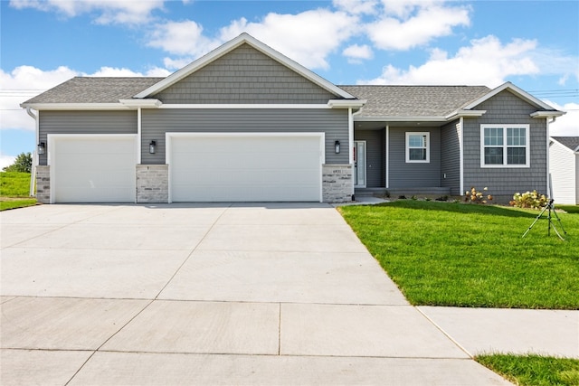 view of front facade with a front yard and a garage