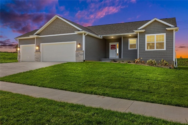 view of front of home with a front yard, driveway, and an attached garage