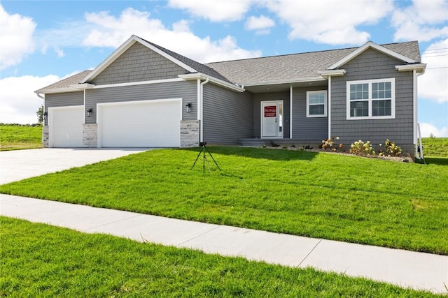 view of front of property with an attached garage, concrete driveway, and a front yard