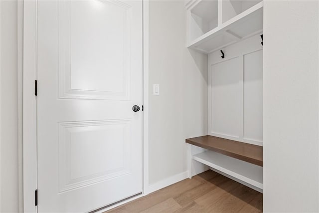 mudroom featuring baseboards and wood finished floors