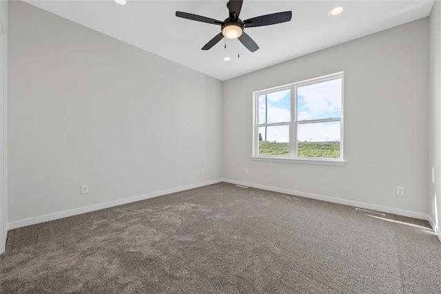 spare room with recessed lighting, carpet flooring, a ceiling fan, and baseboards