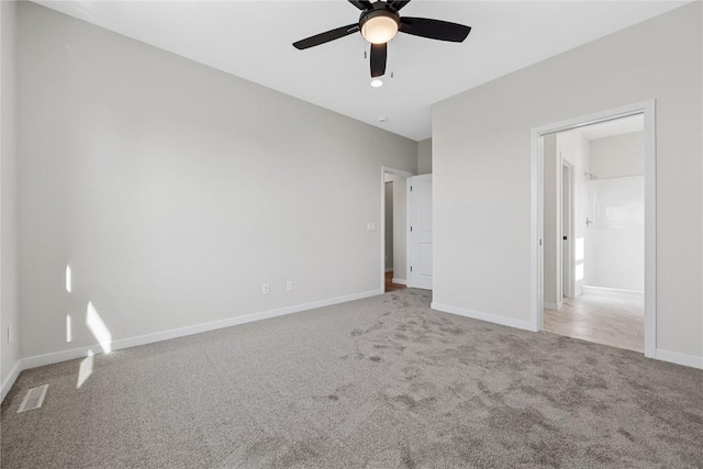 unfurnished bedroom with carpet floors, baseboards, visible vents, and a ceiling fan