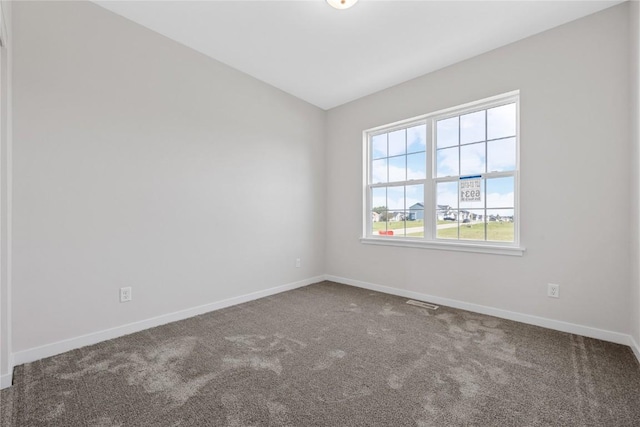 unfurnished room with carpet and baseboards