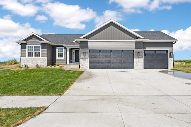 craftsman inspired home featuring a front yard and a garage