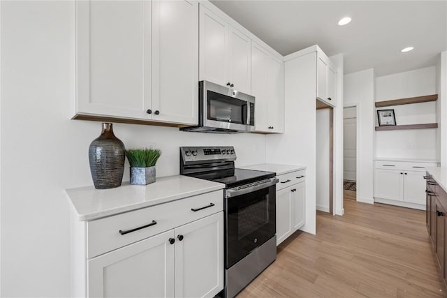 kitchen featuring open shelves, stainless steel appliances, light countertops, white cabinets, and light wood-type flooring