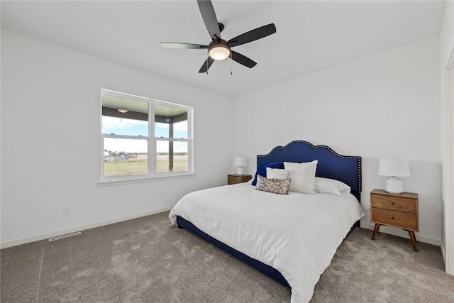 bedroom with ceiling fan, carpet floors, and baseboards