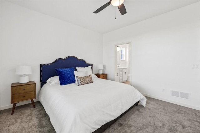 bedroom with ensuite bathroom, carpet, visible vents, and baseboards