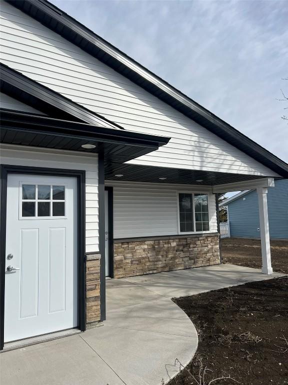 doorway to property with stone siding