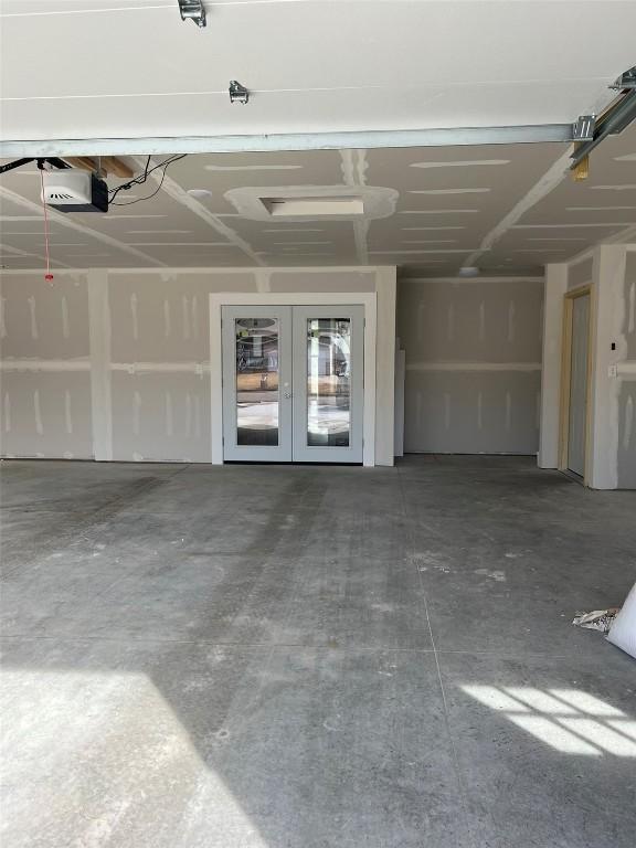 garage featuring a garage door opener and french doors