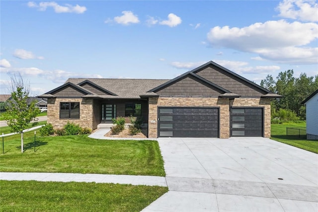 craftsman-style house featuring a garage and a front lawn