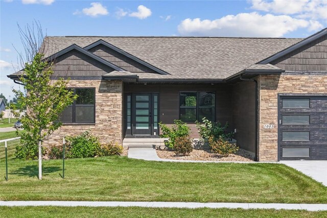 view of front of house with a garage and a front lawn