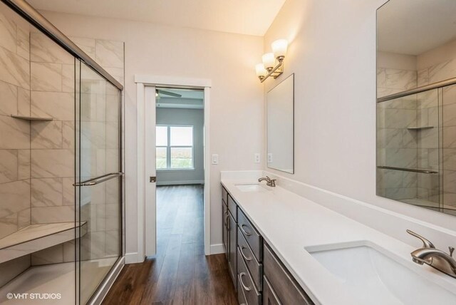 bathroom with a shower with shower door, vanity, and hardwood / wood-style flooring