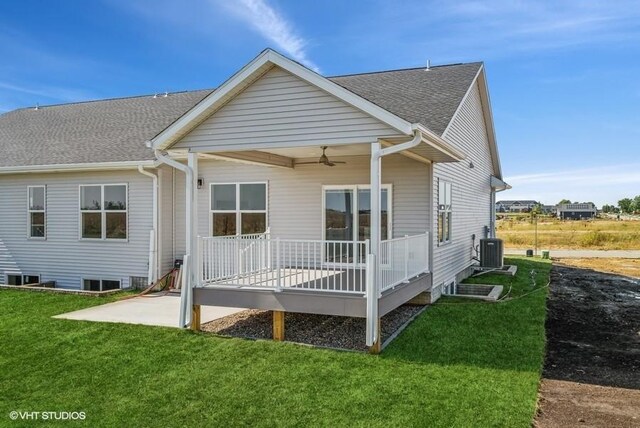 back of house with ceiling fan, a yard, a patio, and central AC