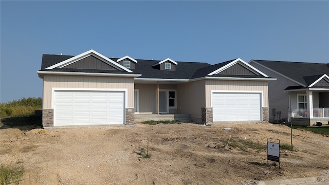 craftsman inspired home with a garage and a porch