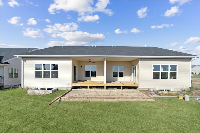 rear view of house with a lawn, ceiling fan, and a wooden deck