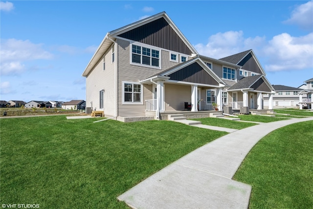 view of front of home with central air condition unit, a porch, a front lawn, and a garage