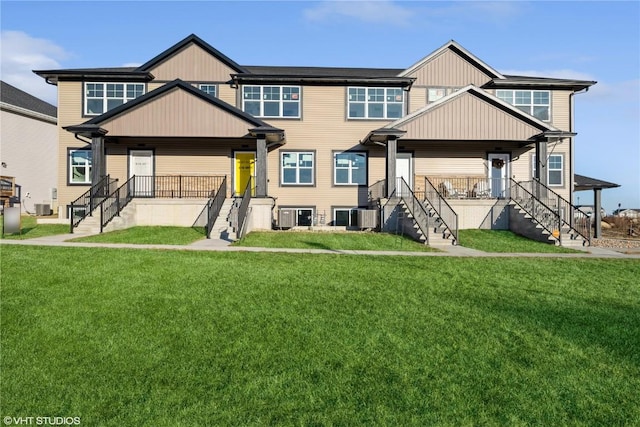 exterior space with cooling unit, a front lawn, and covered porch