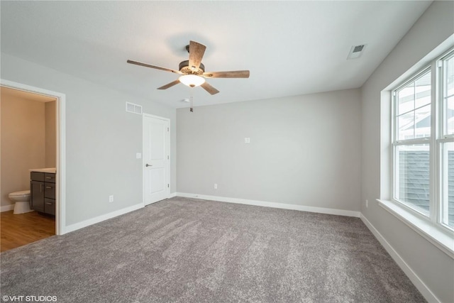 unfurnished bedroom featuring ceiling fan, connected bathroom, and carpet