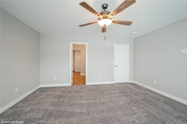 unfurnished bedroom featuring carpet floors, ceiling fan, and ensuite bathroom