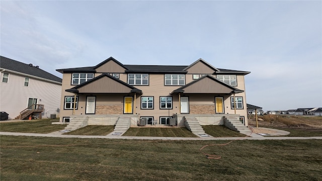 view of front facade featuring a front yard and central AC unit