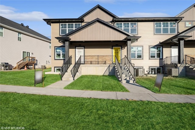 view of front of house with central AC unit, a front lawn, and a porch