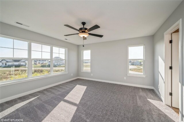 carpeted spare room featuring ceiling fan