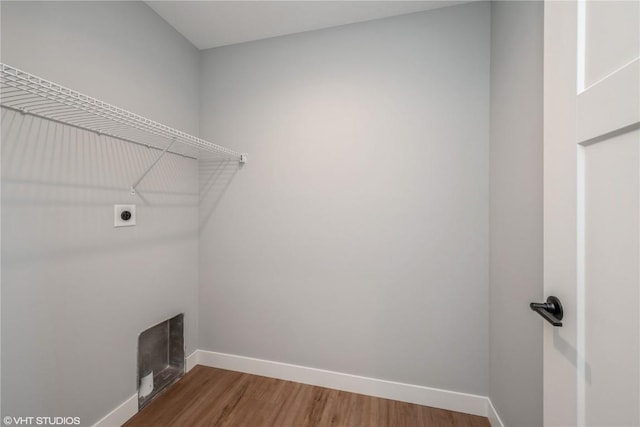 laundry area featuring hookup for an electric dryer and hardwood / wood-style flooring