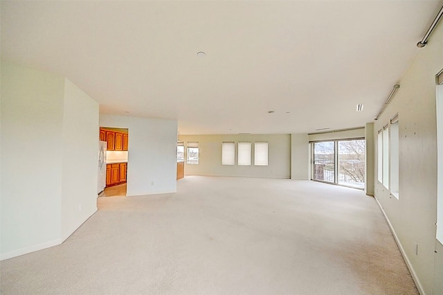 unfurnished living room with light carpet