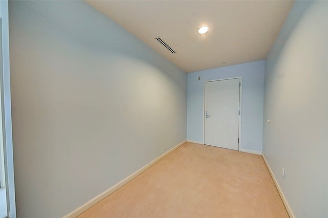 unfurnished room with light carpet