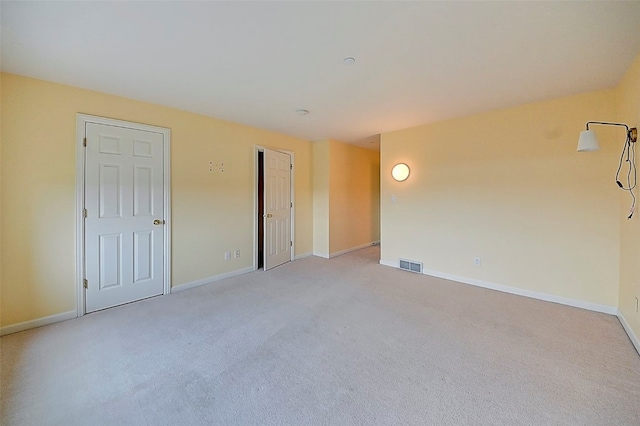 empty room featuring light colored carpet