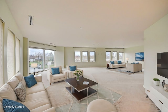 living room with light colored carpet and a wealth of natural light