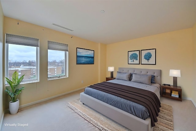 bedroom featuring light carpet