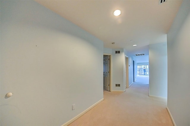 hallway with light colored carpet