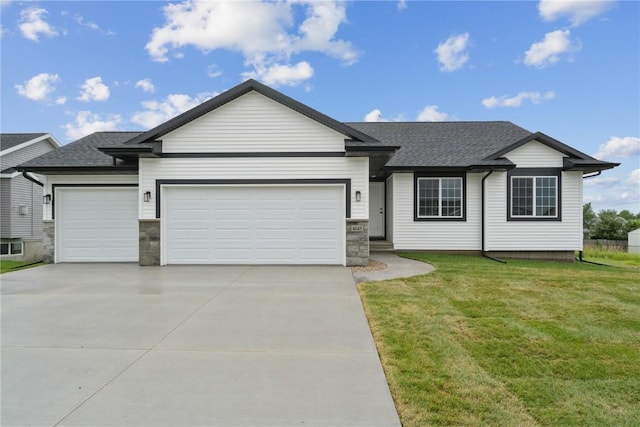 ranch-style home featuring a front yard and a garage