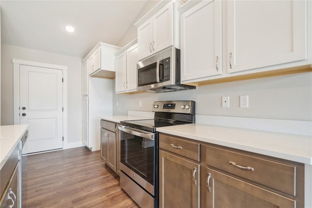 kitchen with white cabinetry, dark hardwood / wood-style flooring, and stainless steel appliances