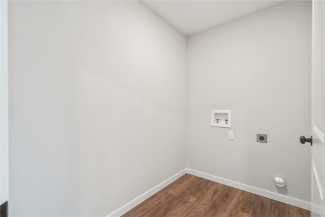 clothes washing area with electric dryer hookup, washer hookup, and hardwood / wood-style flooring