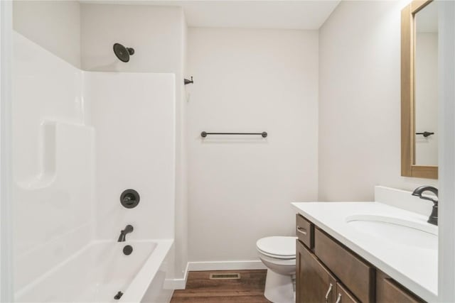 full bathroom featuring shower / tub combination, vanity, wood-type flooring, and toilet