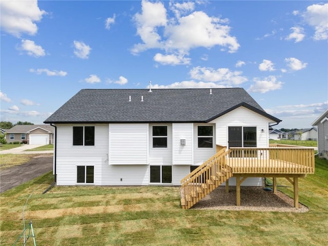 back of house with a wooden deck and a yard