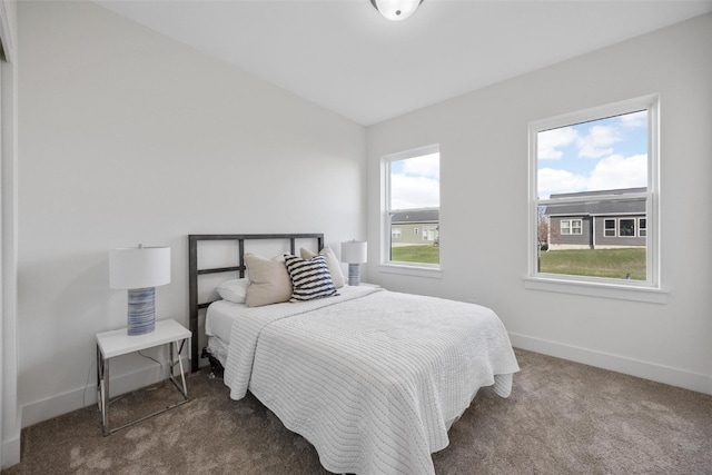 bedroom with carpet flooring and lofted ceiling