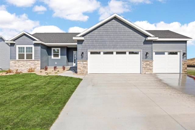 craftsman house with a front yard and a garage