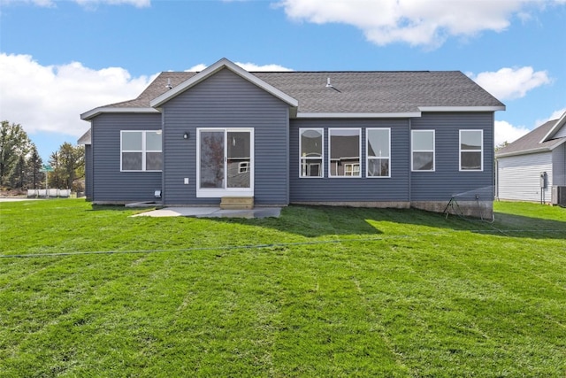 rear view of house with a patio area, cooling unit, and a lawn