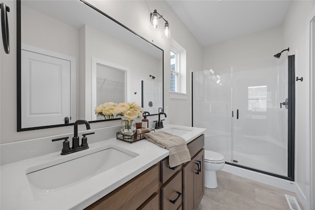 bathroom featuring vanity, walk in shower, toilet, and tile patterned floors