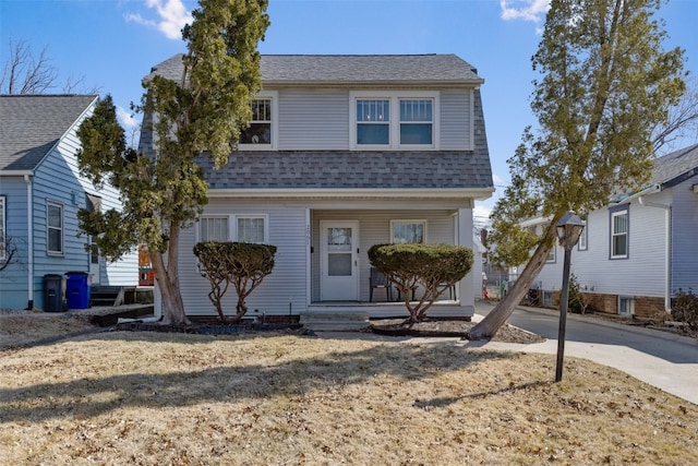 view of front facade featuring concrete driveway and roof with shingles