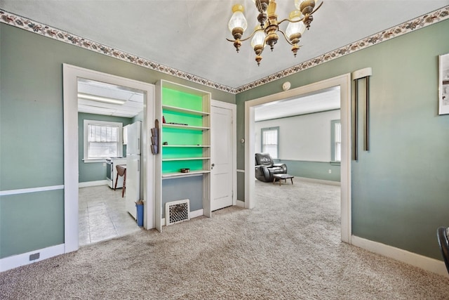 interior space featuring an inviting chandelier, visible vents, and baseboards