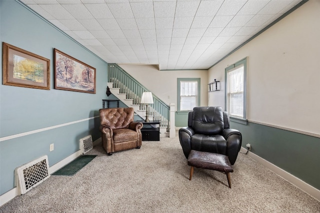 sitting room featuring stairway, carpet flooring, baseboards, and visible vents