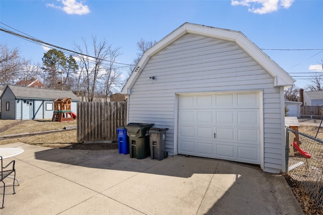 detached garage with driveway and fence