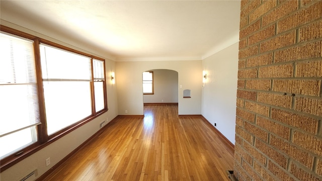 unfurnished room with light hardwood / wood-style floors and a baseboard radiator